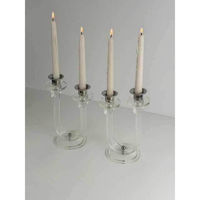 A pair of Art Deco acrylic glass and chrome candelabras, made in England circa the 1930s, combining clear geometric forms...