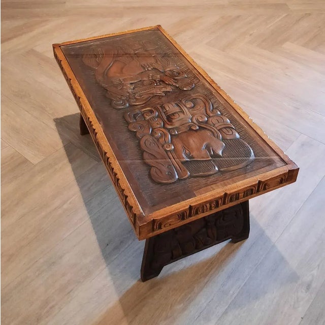 This wooden handcrafted coffee table was produced in Honduras in the 1960s/1970s. It's decorated with Mayan motifs. The...