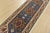A traditional tribal Heriz runner hand-knotted with an all-wool pile on a cotton foundation. This oriental rug features...