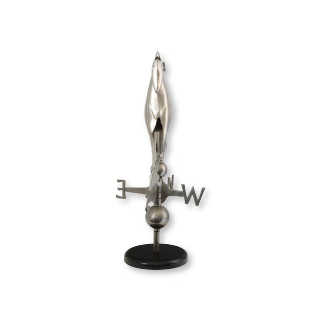 A beautifully sculpted horse weather vane, rendered in polished metal and mounted on a sleek black marble base. Inspired...