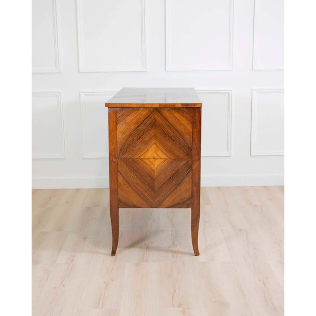 A striking Italian 18th century Directoire chest of drawers, beautifully crafted in walnut and distinguished by its bold...