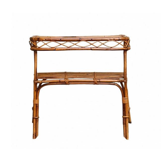 An elegant, multi-shelf entryway console table made in the 1960s with a curved bamboo frame and geometric details...