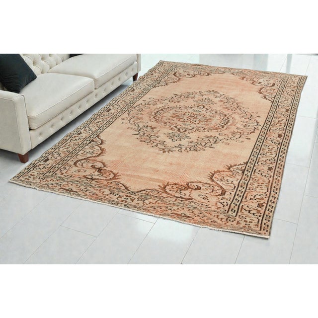 This is a vintage Turkish Oushak rug from the 1960s. The piece was hand-knotted.