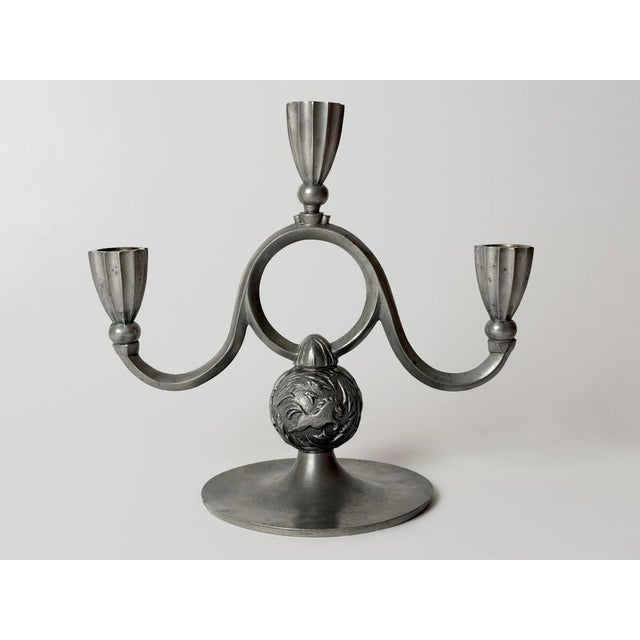 An expressive swedish three-light pewter candelabra by svenskt tenn, combining the elegance of art deco with the...
