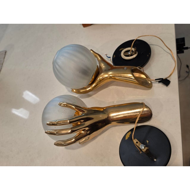 The Vintage Pair of Maison Arlus Gold Bronze Hand Held Globe Sconces are a unique and stylish lighting fixture from the...