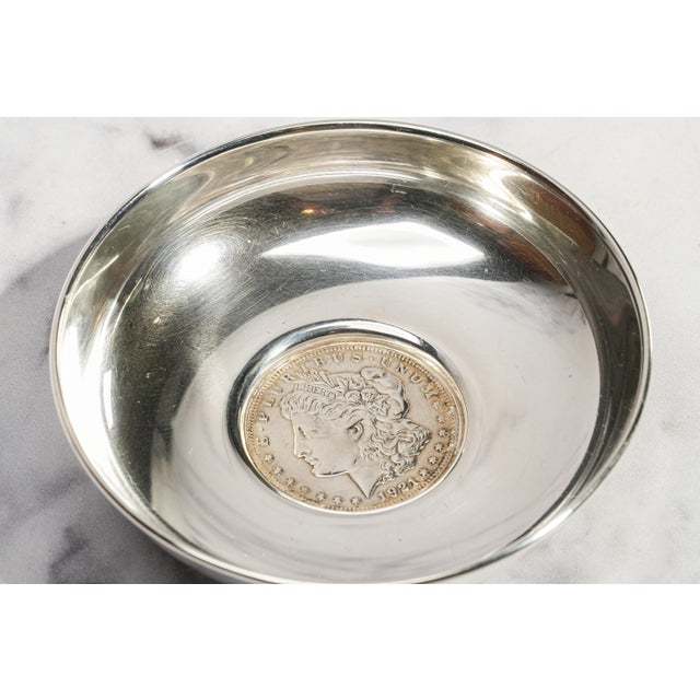 A handsome blend of American silver and mid-century craftsmanship, this circa 1940s sterling silver catchall dish is...