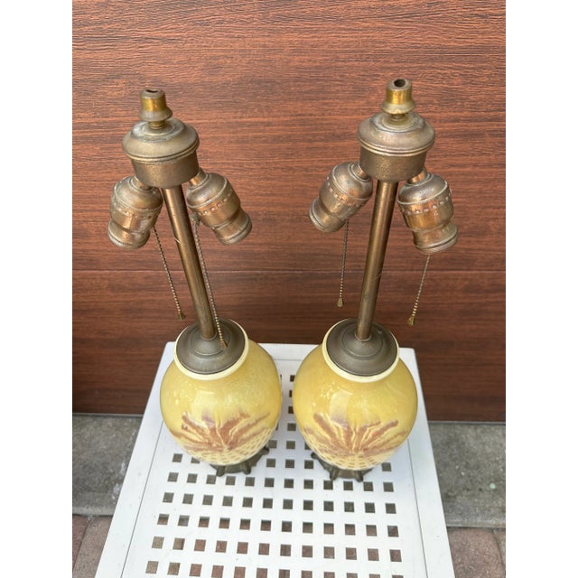 Add a touch of coastal boho chic to your living space with this pair of antique palm tree table lamps. These double socket...