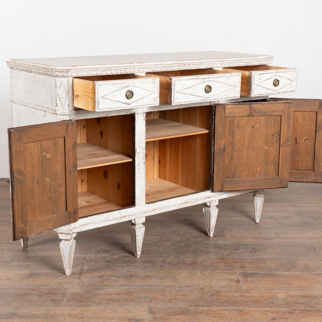 19th century Swedish sideboard, crafted in pine. The piece features a classic three drawer over three door configuration...