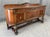 This circa 1930s Jacobean-style sideboard showcases richly figured wood, substantial turned supports, and finely detailed...