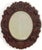 A fine Black Forest oval wall mirror from the late 19th century, featuring a decoratively carved frame with beautiful...
