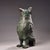 This is a cast bronze ritual vessel in the form of a standing owl, featuring a detachable lid shaped as the bird's head....