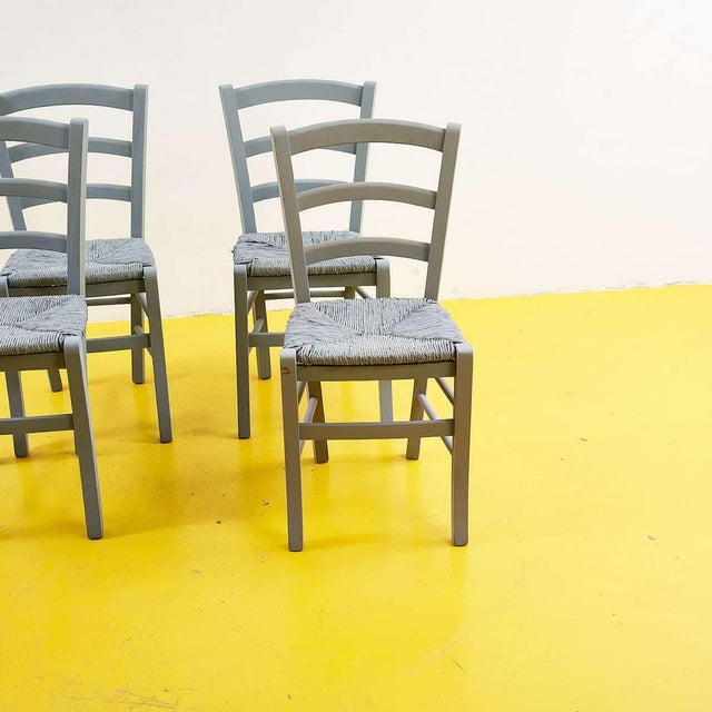 This stunning set of four rustic-style chairs combines comfort and timeless design. Featuring a sturdy grey-painted wooden...