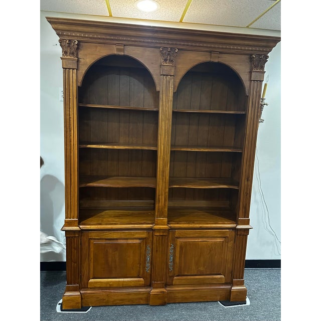 Acanthus carved Birchwood open double bookcase with cabinet storage beneath. Neoclassical style, with ample storage....