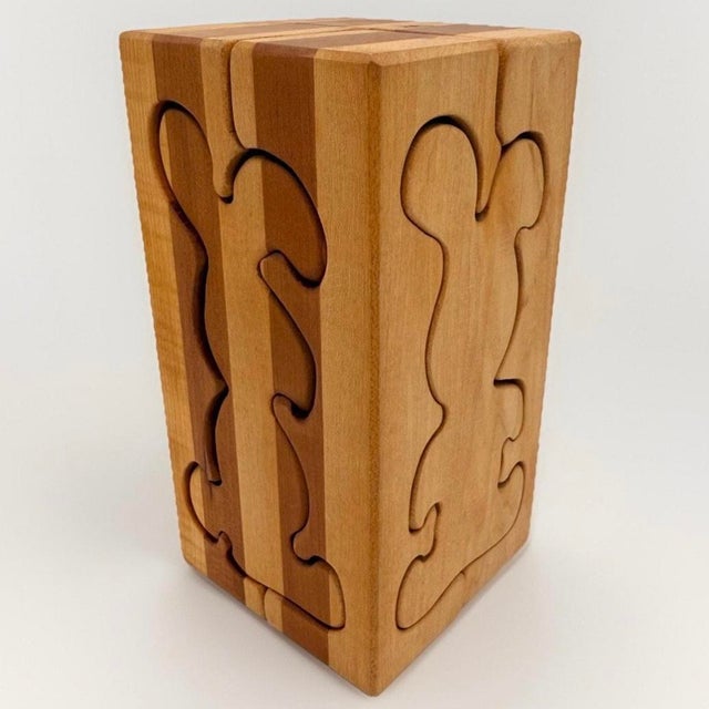 Vintage Scandinavian wooden puzzle sculpture composed of four interlocking carved blocks that form a cube. When separated,...