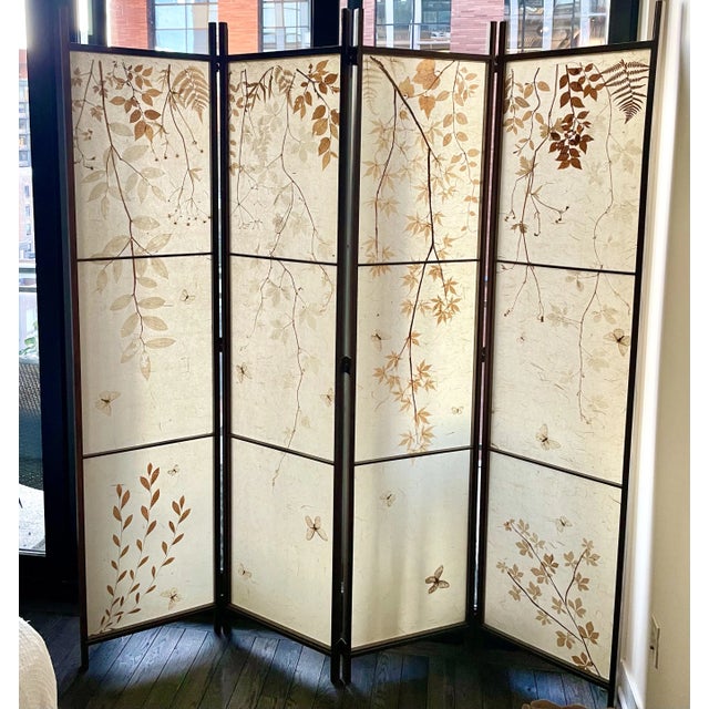Unusual and exquisite folding four-panel floor screen featuring a rich brown elmwood frame, showcasing a stunning design...