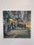 This oil on board painting captures a bustling urban scene at twilight, with figures strolling along the sidewalk under...