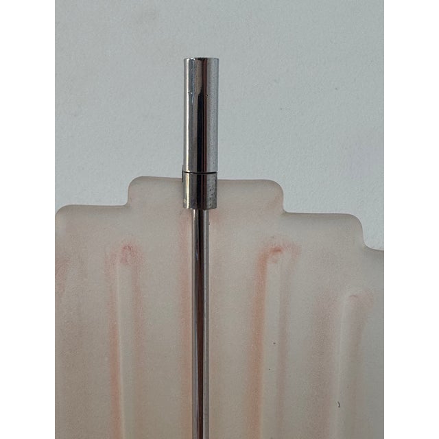 Pair of wall sconces, each with a chrome-plated metal frame and a Murano glass diffuser, produced in Italy in the 1970s....