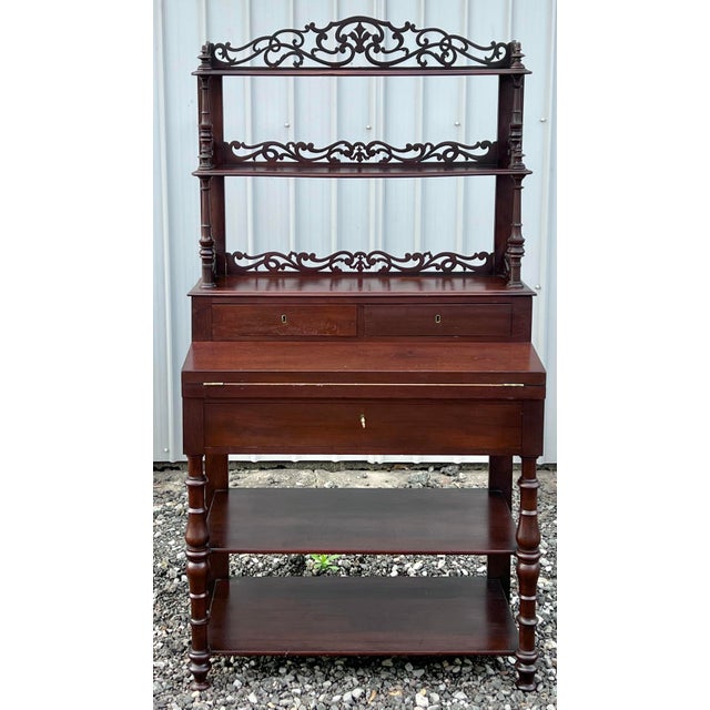 Wonderful and whimsical 19th-century Victorian mahogany etagere desk featuring a drop-front writing surface. This piece is...