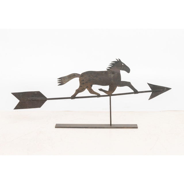 American Sheet Iron Horse Weathervane, mounted on an iron base. Overall: 20.25" H x 46.25" W x 3" D. Provenance: From a 21...