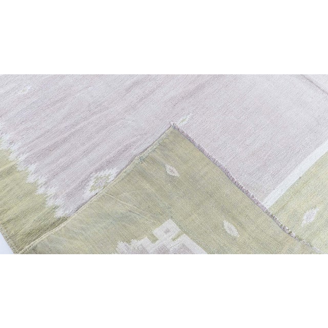 This elegant 1945 Indian Dhurrie rug reflects the quiet sophistication and timeless craftsmanship associated with...