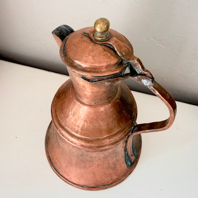 Bring authentic farmhouse warmth to your home with this antique copper hammered ewer. The bell‑shaped silhouette and...