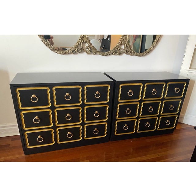 Pair of “España” Style Dresser Chests in the Style of Dorothy Draper. This striking pair showcases a rich, ebony finish...