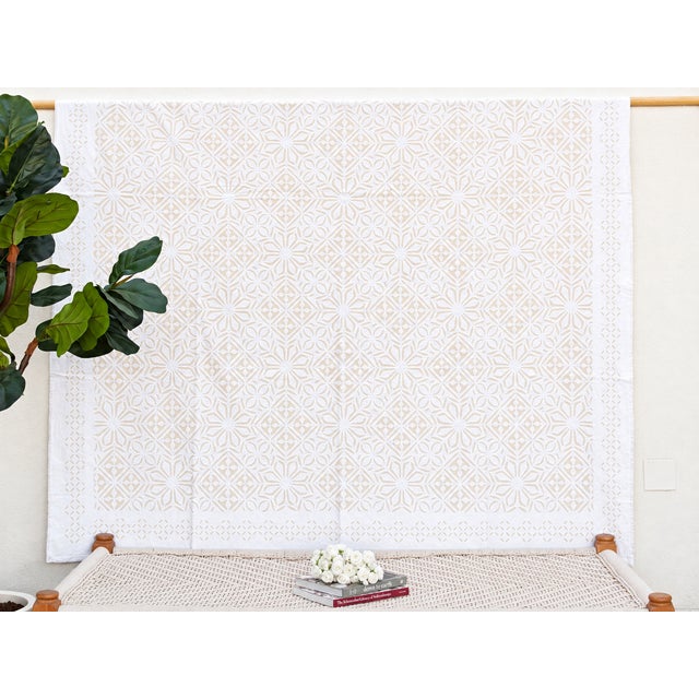 A lightweight cotton coverlet from Western India, beautifully adorned with intricate handcrafted appliqué cutwork. The...