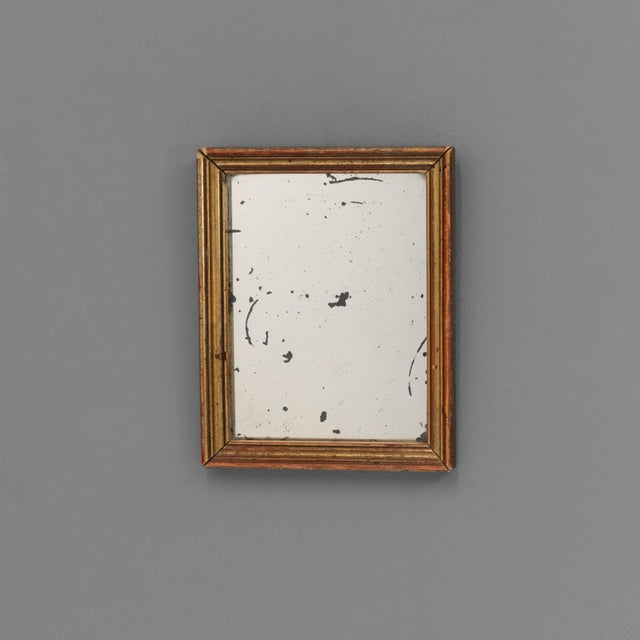 Small gilded mirror with aged glass. Circa 1900.