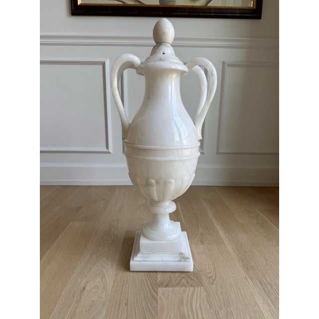 A truly monumental hand-carved Italian alabaster covered urn of exceptional scale and timeless neoclassical design....