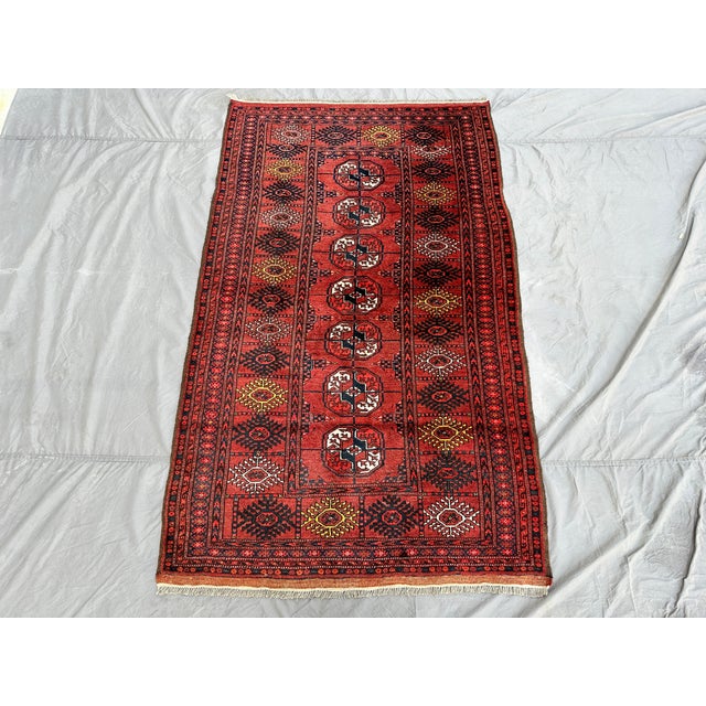 This hand-knotted Khal Mohammadi runner features a single column of octagonal guls down the center field, flanked by rows...