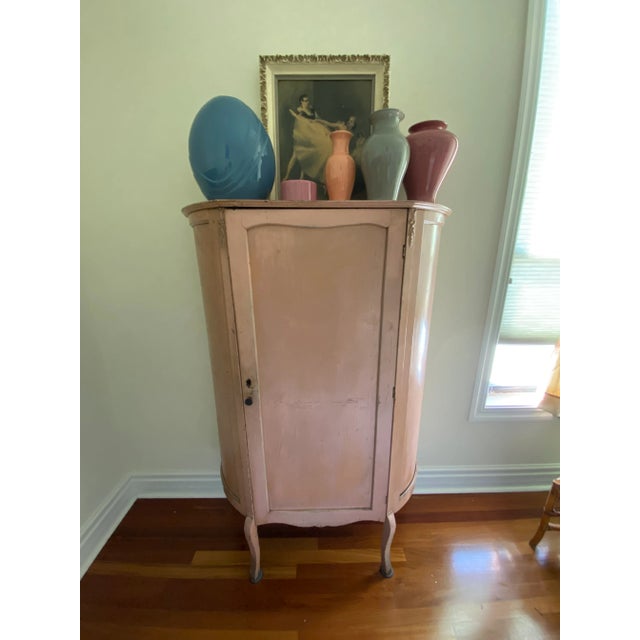 This exquisite French display cabinet features a gently bowed form, elegant cabriole legs, and refined carved floral...