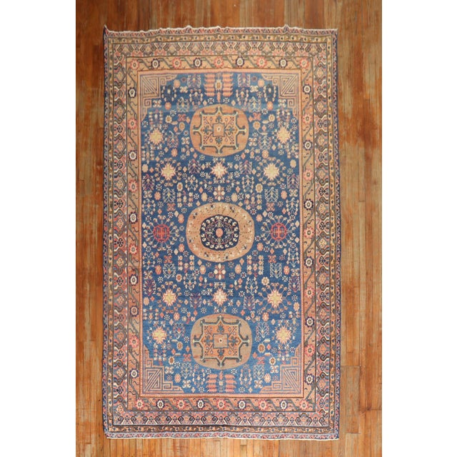 An early 20th century Khotan gallery size rug. Measures: 6'10" x 13'2". Khotan rugs hail from East Turkestan. Due to its...