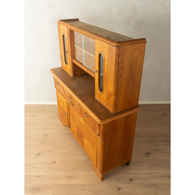 A wonderful two-part Art Deco kitchen cabinet from the 1920s. High-quality, walnut-veneered blockboard construction with...