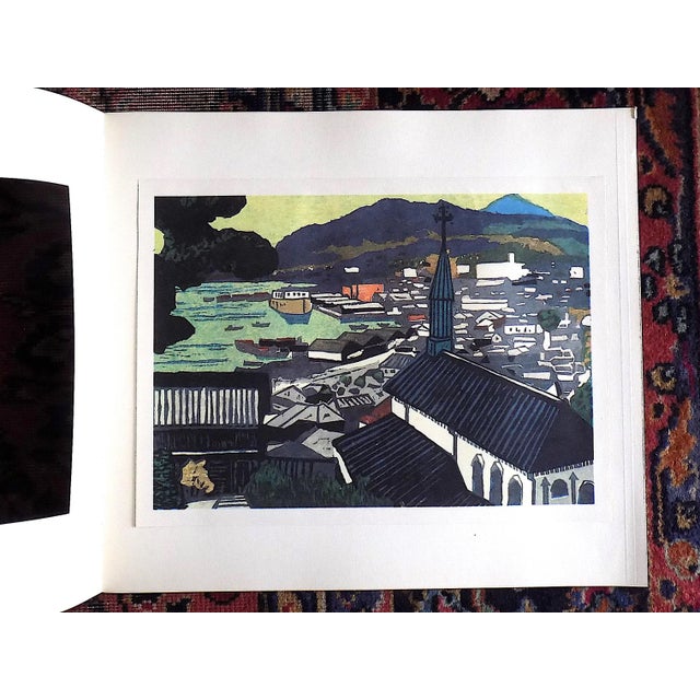 This vintage lithograph depicts a Japanese woodblock print of a Cityscape in Japan. It was published in Japan by Kyoto...