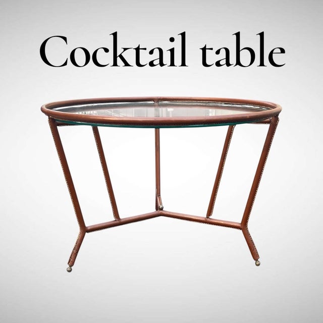 A Rare French Midcentury Modern hand stitched leather cocktail table by Jacques Adnet, circa 1955. Adnet had a rare talent...