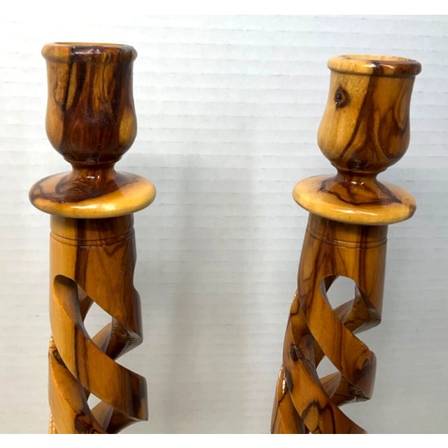 Beautifully handcrafted in the Holy Land, this elegant set of olive wood spiral pillar candlestick holders showcases the...