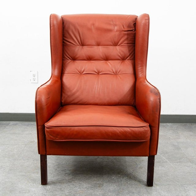 Outstanding top grain red leather wingback lounge chair. This piece comes in a rich and high quality leather. This chair...