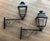 This pair of substantial and decorative outdoor lanterns on stands is made of iron and sheet metal. It is French. Circa 1950