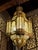 Monumental Arab-Moorish Hanging Lantern in Pierced Metal with Translucent Panels, circa 1920–1940 A striking and highly...