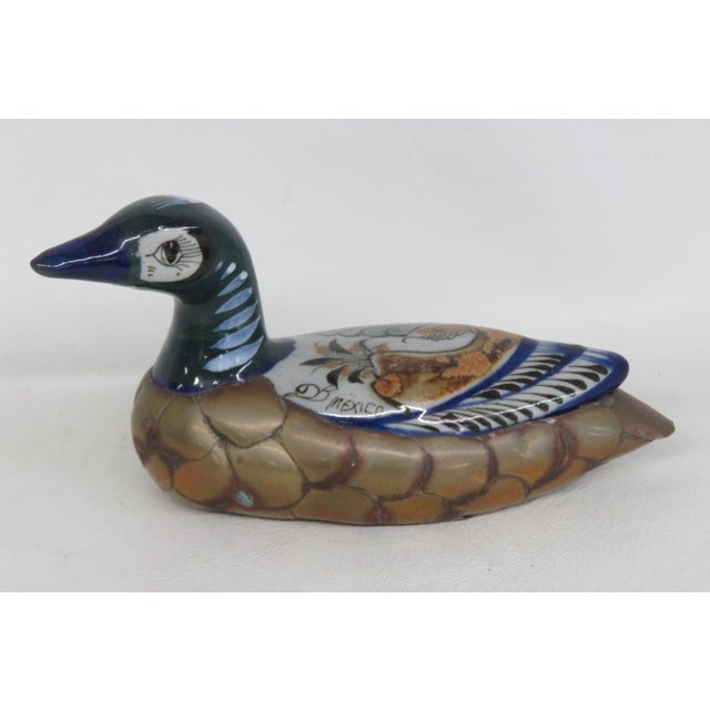 This beautiful Duck Statue is made of brass plating and ceramic. This gorgeous mixed medium decorative duck presents the...