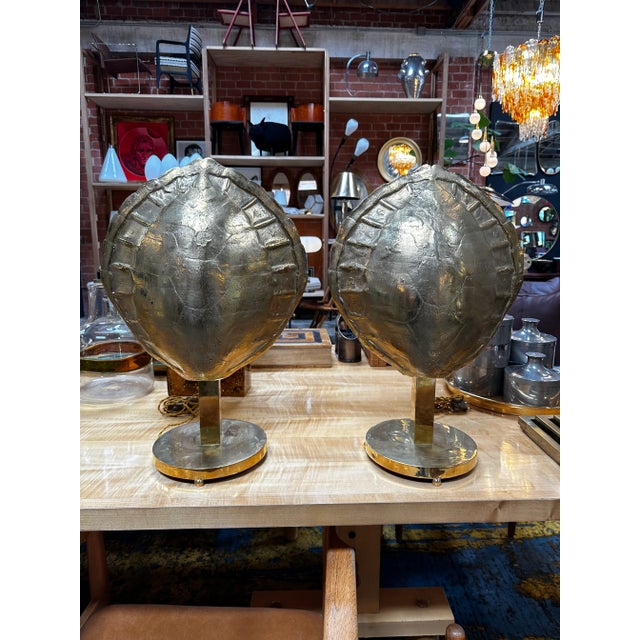 The Pair of fully brass shell table lamps made in Italy in the 1960s is a beautiful example of mid-century modern lighting...