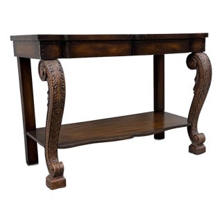 Vintage Neoclassical Revival Console Table With Ornately Carved Scroll Supports and Lower Shelf For Sale