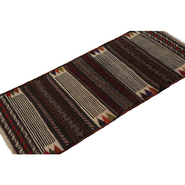 Handwoven in wool, originating from Afghanistan circa 1950-1960, its 2x5 size and design may signify origins as a table...