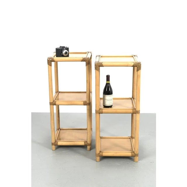 Pair nice bamboo stands. They're concected by leather and designed in the seventies. They're in a good vintage condition....