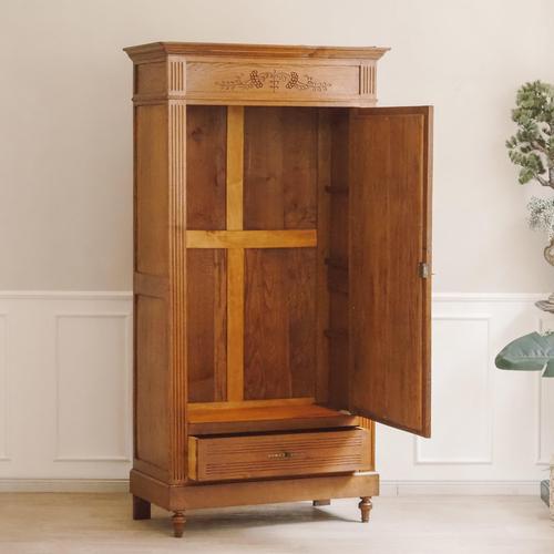 A single-door mirrored wardrobe in oak, crafted in the louis xvi revival style around 1900. The narrow front is clearly...