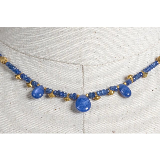 A striking yet delicate necklace comprised of faceted blue sapphire beads with three pear shaped drops at the front....