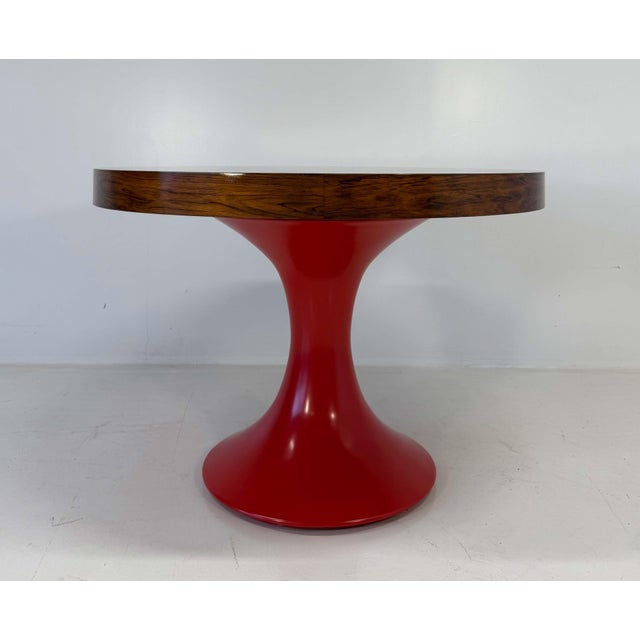 Elegant Italian round table from the 1950s, featuring a refined ziricote wood top with rich, symmetrical grain patterns...