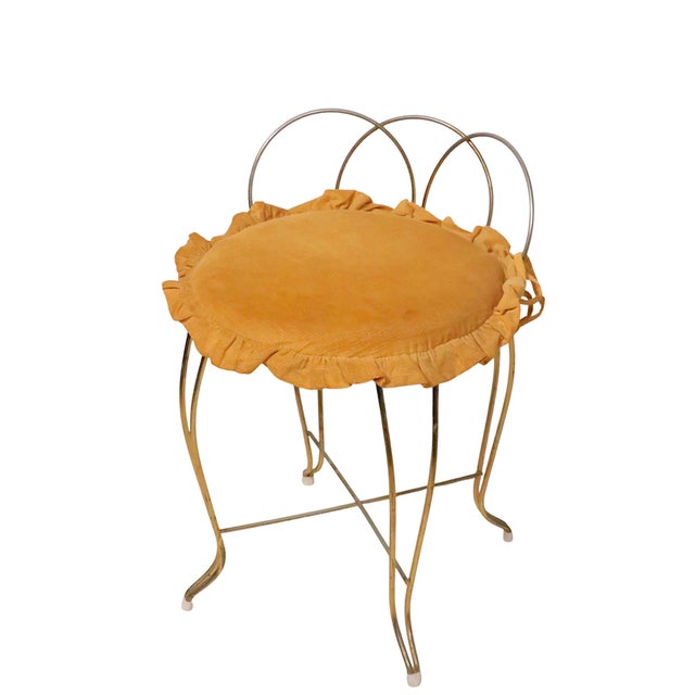 Voguish Hollywood Regency vanity stool constructed of gold finish metal rods, with a removable upholstered pad seat. This...