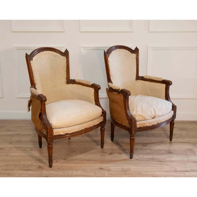A finely proportioned pair of French bergères dating to circa 1830, reflecting the continued refinement of late Empire to...