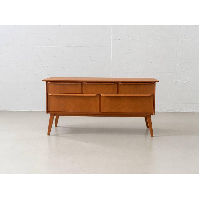 An elegant mid-century chest of drawers by Austinsuite, likely from the 1960s, with a very balanced, typically British-...